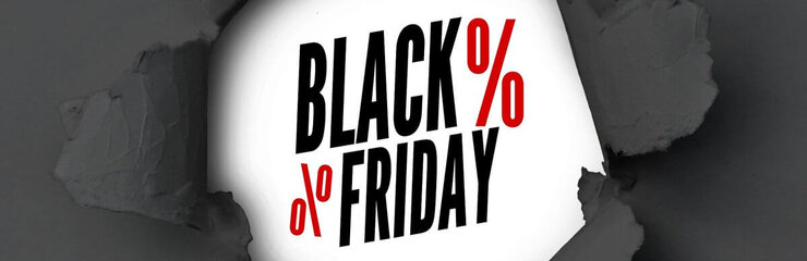 black paper ripped in the middle to show Black Friday written in black with 2 red percentage signs