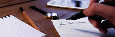 making a list of new year's resolutions on a piece of paper