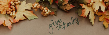 written text give thanks surrounded by autumn leaves and decor