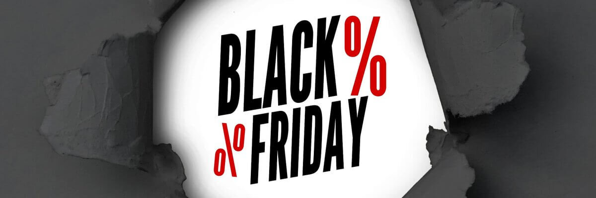 black paper ripped in the middle to show Black Friday written in black with 2 red percentage signs