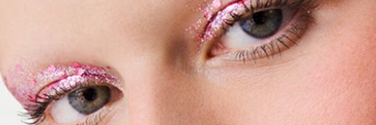 women's eyes with pink glitter eyeshadow on her eylids