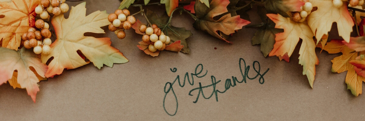 written text give thanks surrounded by autumn leaves and decor