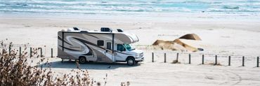 Rv on a sandy road in the middle of a beach