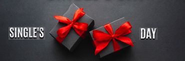 Fondo negro con dos cajas de regalo con lazo rojo y escrito Single's day