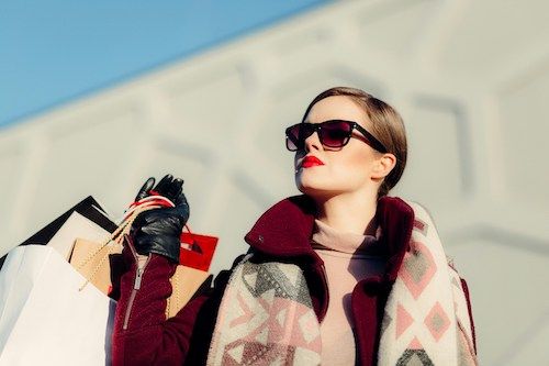 Mulher com sacos de compras na mão