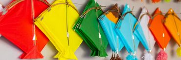 Colorful kites hanging on display, ready for Makar Sankranti celebrations