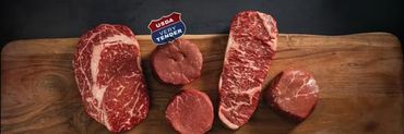Cuts of meat displayed on a wooden cutting board